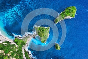 Aerial view at sea and rocks. Turquoise water background from top view. Summer seascape from air. Atuh beach, Nusa Penida, Bali, I