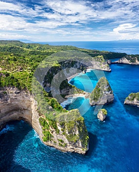 Aerial view at sea and rocks. Turquoise water background from top view. Summer seascape from air. Atuh beach, Nusa Penida, Bali, I