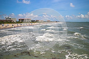 Aerial view of sea waves breaking sandy beach