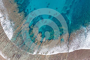 Aerial view of Sea waves reaching tropical beach landscape