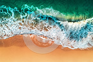 Aerial view of sea waves and sandy beach