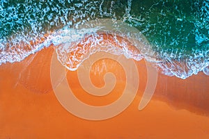 Aerial view of sea waves and sandy beach