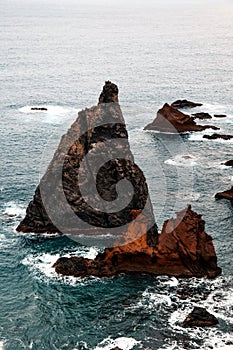 Aerial view of sea waves washing rocky beach in Ponta do Rosto photo