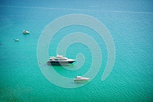 Aerial view of sea and yacht. Sailing ship in the middle of ocean, top view, summer background. Amazing view to Yacht