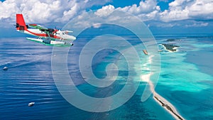 Aerial view of a seaplane approaching island in the Maldives