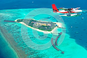 Aerial view of a seaplane approaching island in the Maldives