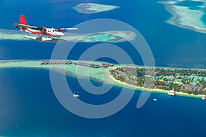 Aerial view of a seaplane approaching island in the Maldives