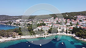 Aerial view of the seascape with ships and boats against the green coast with buildings in Croatia