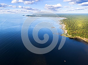 Aerial view of seashore with beach, lagoons. Coastline with sand and water. Landscape. Aerial photography. Birdseye. Sky, clouds.