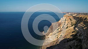 Aerial view seashore with high limestone cliffs over blue sea