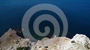 Aerial view seashore with high limestone cliffs over blue sea