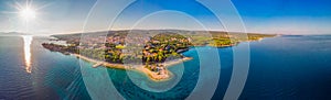 Aerial view of seaside promenade in Supetar town on Brac island with palm trees and turquoise clear ocean water, Supetar, Brac, Cr