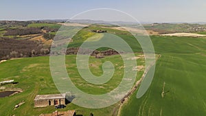 Aerial View of a Secluded Farmhouse in the Rolling Hills of Tuscany Italy in Spring