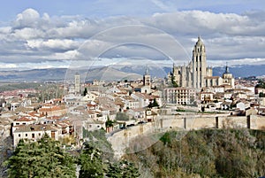 Aerial view on Segovia Cathedral, roman catholic religion church at wintertime in Segovia, Spain. Dramatic vivid cloudscape,