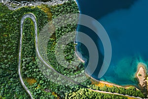 Aerial view serpentine road and forest with sea drone landscape in Norway