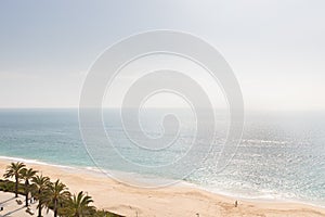 Aerial view of Sesimbra beach, Portugal with palm trees