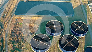 Aerial view of sewage treatment plant. Industrial water treatment with round water tanks for sewage recycling from drone