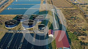 Aerial view of sewage treatment plant. Industrial water treatment with round water tanks for sewage recycling from drone
