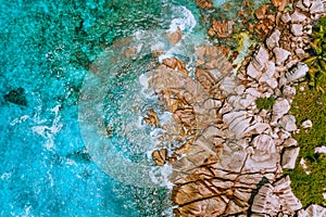 Aerial view of Seychelles Anse Cocos beach at La Digue Island. Pure crystal clear turquoise ocean water and bizarre