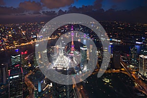 Aerial View of Shanghai Cityscape over the Pudong Financial District at night. Trade zone skyline and Huangpu River.