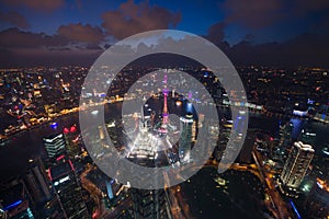 Aerial View of Shanghai Cityscape overlooking the Pudong Financial District at night. Trade zone skyline and Huangpu River.