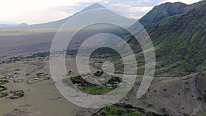 Aerial View on Sheep Flock in Maasai village in front of the Ol Doinyo Lengai Mountain of God in the Maasai language