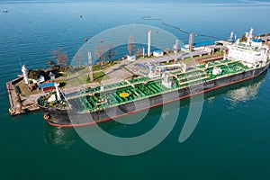 Aerial view of ship tanker vessel loading in gas and oil terminal station refinery, Global trading import export