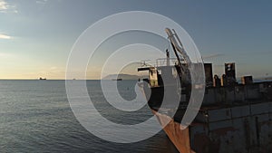 Aerial view of the ship washed ashore. Shot. Top view of an abandoned old and rusty shipwreck on a stormy day