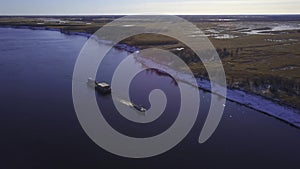 Aerial view of shipping barge transporting goods up the Mississippi River on the Missouri and Illinois border.