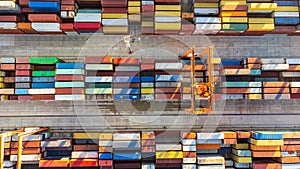 Aerial view of shipping container port terminal. Colourful pattern of containers in harbor. Maritime logistics global