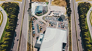 Aerial view of shopping mall parking lot with highway nearby