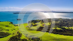 Aerial view on a shore on sunny harbor with small houses. Waiheke Island, Auckland, New Zealand.