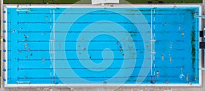 Aerial view shot of people competing in water polo in turquoise water pool