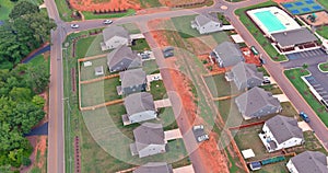 Aerial view showcases an expansive unfinished subdivision housing complex with rows houses in various stages