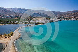 Aerial view showing the causeway connecting Elounda to Kolokitha island along with the remains of the Minoan city of Olous Crete