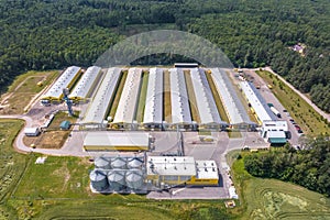 Aerial view on silos and agro-industrial livestock complex on agro-processing and manufacturing plant with modern granary elevator