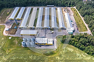 Aerial view on silos and agro-industrial livestock complex on agro-processing and manufacturing plant with modern granary elevator