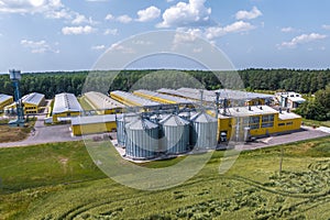 Aerial view on silos and agro-industrial livestock complex on agro-processing and manufacturing plant with modern granary elevator