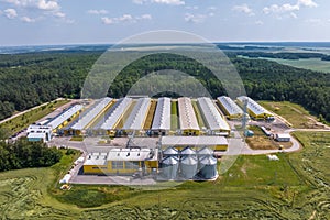 Aerial view on silos and agro-industrial livestock complex on agro-processing and manufacturing plant with modern granary elevator