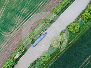 aerial view of a single moored narrowboat in a rural setting