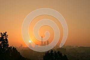 Aerial view of the skyline of Bejing, China in fog with the evening sky and sunset