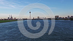 Aerial view of the Skyline of Duesseldorf while flying deep and fast over the river Rhine - Germany - Europe