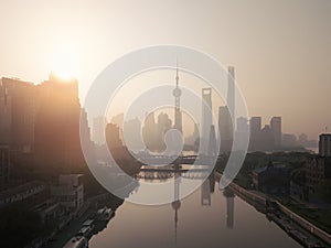 Aerial view of skyscraper and high-rise office buildings in Shanghai Downtown with fog, China. Financial district and business