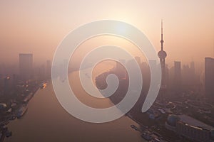 Aerial view of skyscraper and high-rise office buildings in Shanghai Downtown with fog, China. Financial district and business