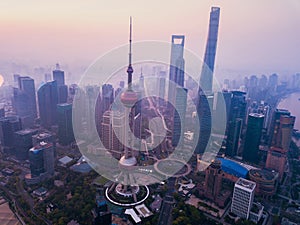 Aerial view of skyscraper and high-rise office buildings in Shanghai Downtown with fog, China. Financial district and business