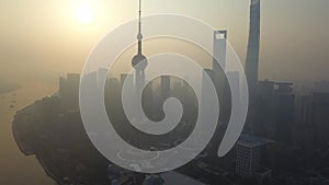 Aerial view of skyscraper and high-rise office buildings in Shanghai Downtown with fog or mist, China. Financial district and