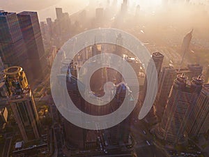 Aerial view of skyscraper and high-rise office buildings in Shanghai Downtown with fog or mist, China. Financial district and