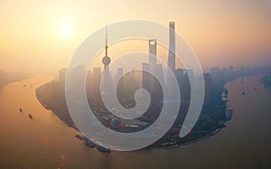 Aerial view of skyscraper and high-rise office buildings in Shanghai Downtown with fog or mist, China. Financial district and