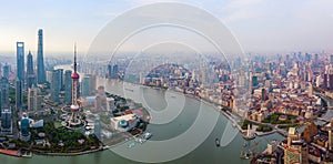 Aerial view of skyscraper and high-rise office buildings in Shanghai Downtown with Huangpu River, China. Financial district and