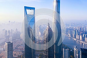 Aerial view of skyscraper and high-rise office buildings in Shanghai Downtown with Huangpu River, China. Financial district and